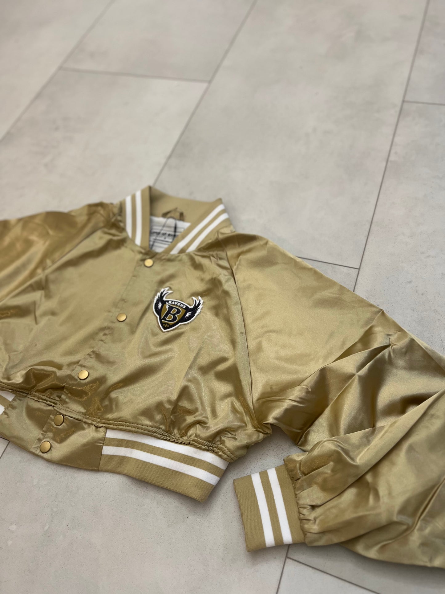 Cropped Satin “Ravens” sideline jacket.