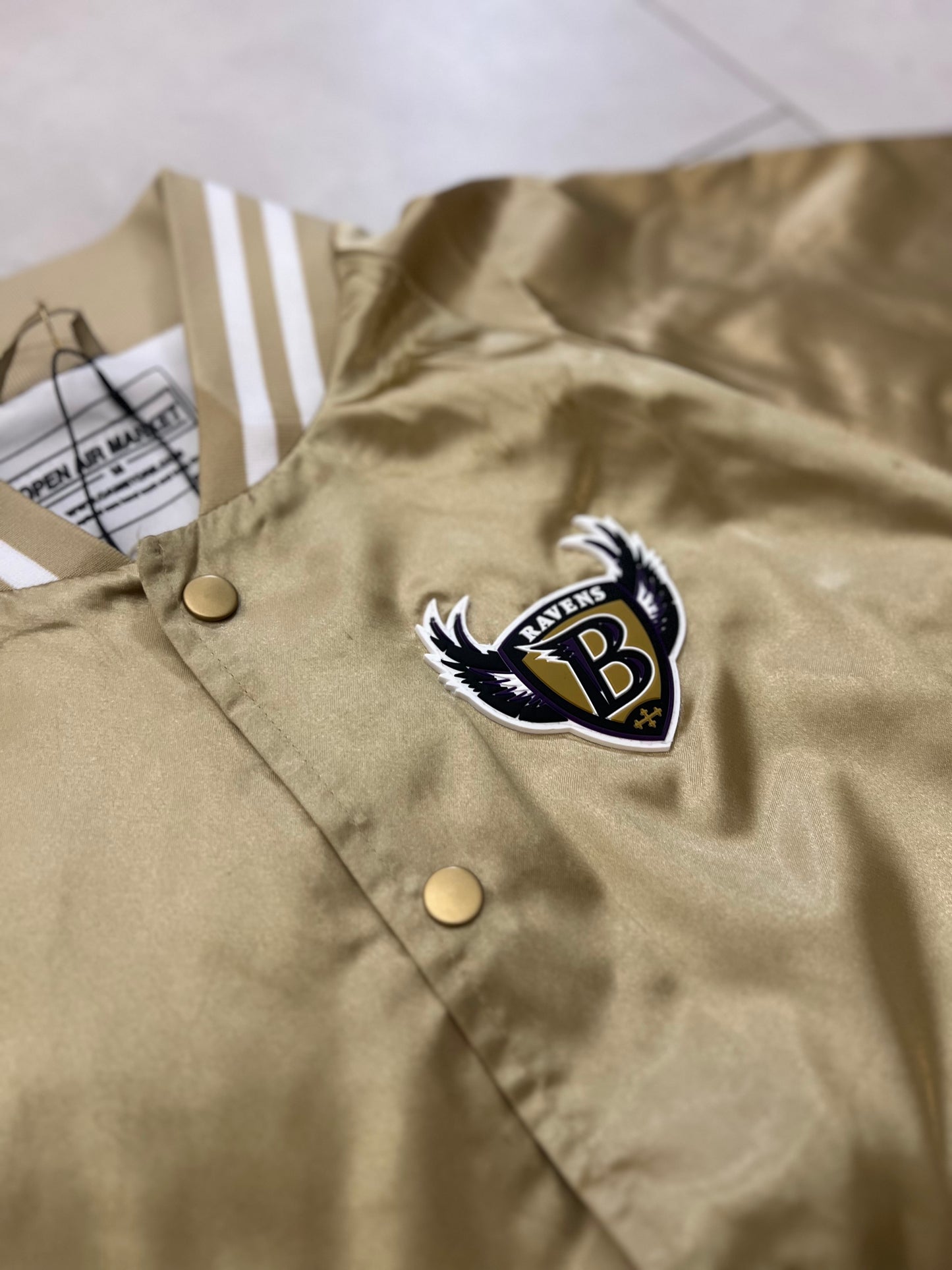 Cropped Satin “Ravens” sideline jacket.